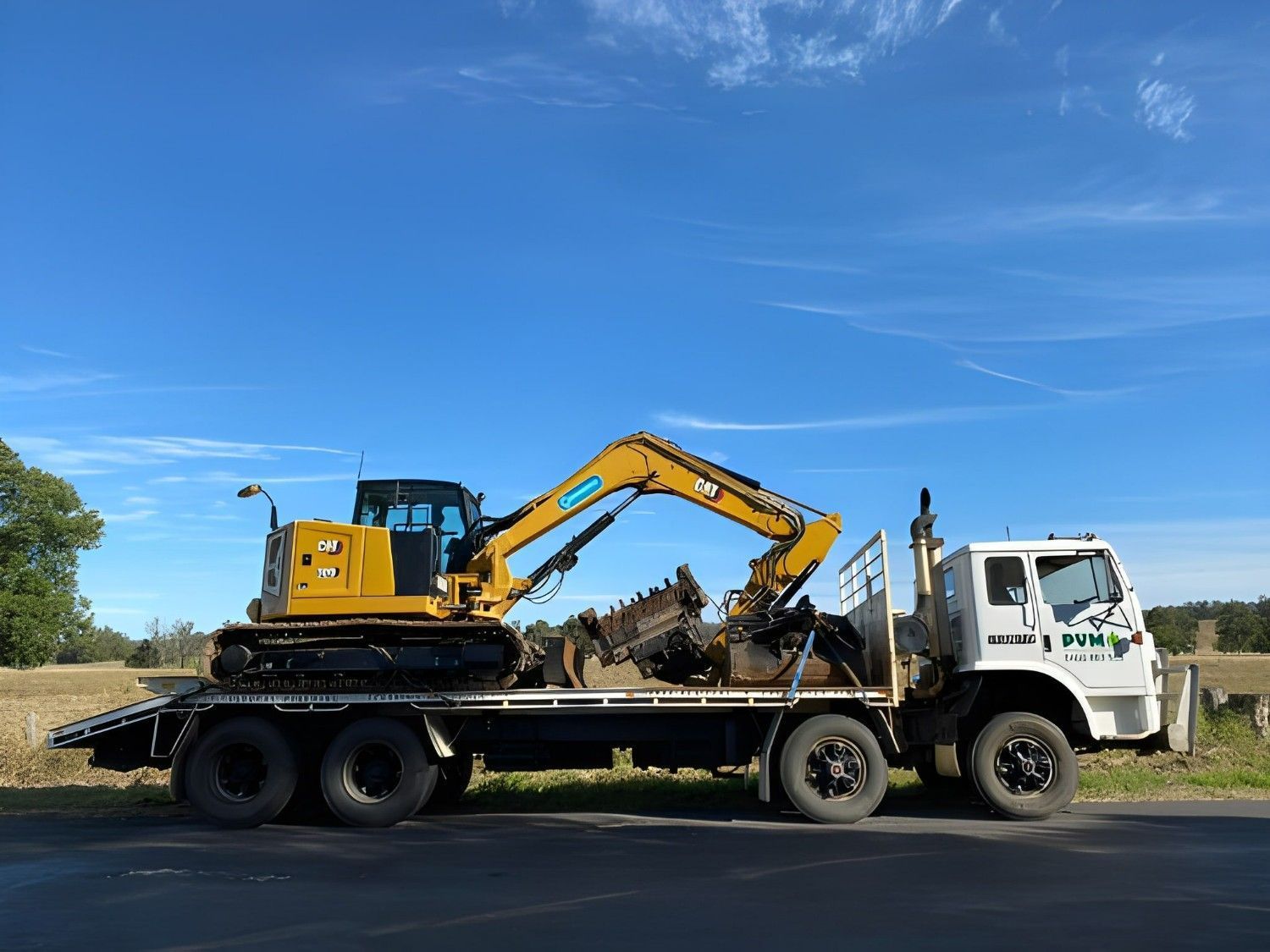 A Yellow Excavator on a Flatbed Truck — PVM Contracting in Casino, NSW