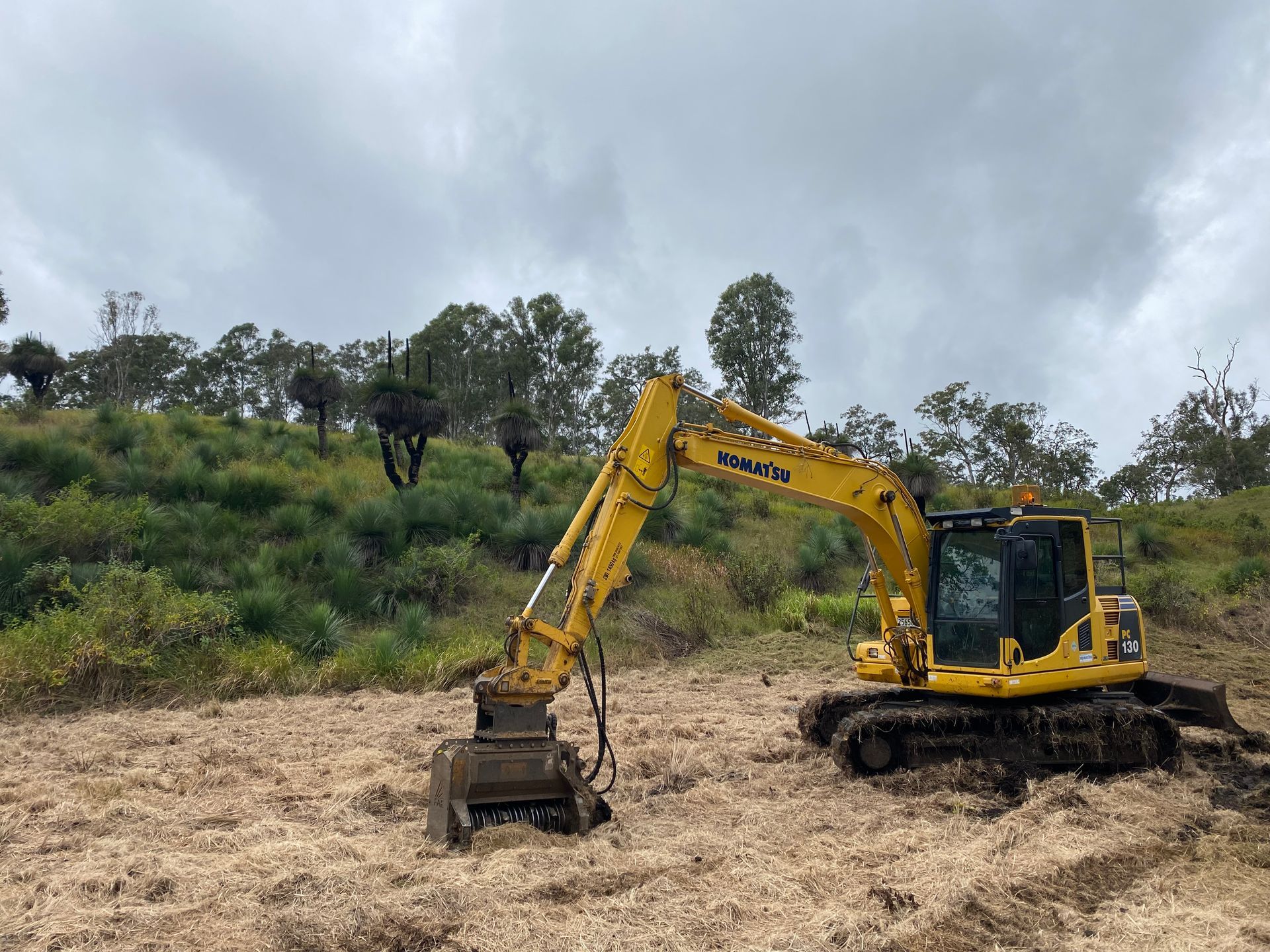 A Yellow Excavator on a Cleared, Wooded Hillside — PVM Contracting in Alstonville, NSW