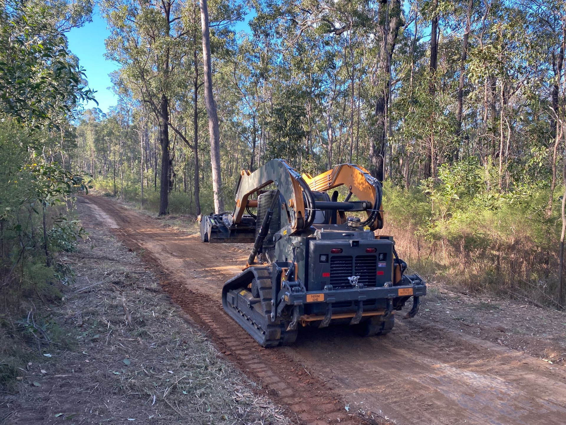 A Excavator Clearing a Dirt Road in a Forest — PVM Contracting in Alstonville, NSW
