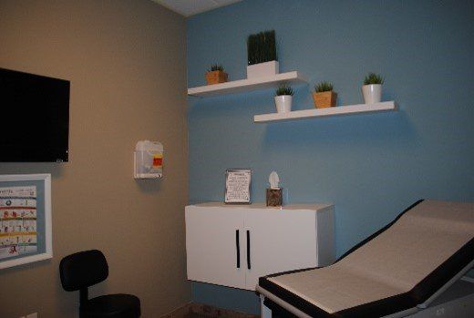 A doctor 's office with a couch and a television | United Critical Care