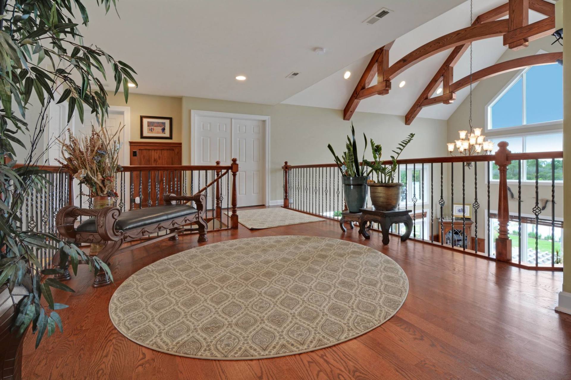 a living room with hardwood floors and a round rug