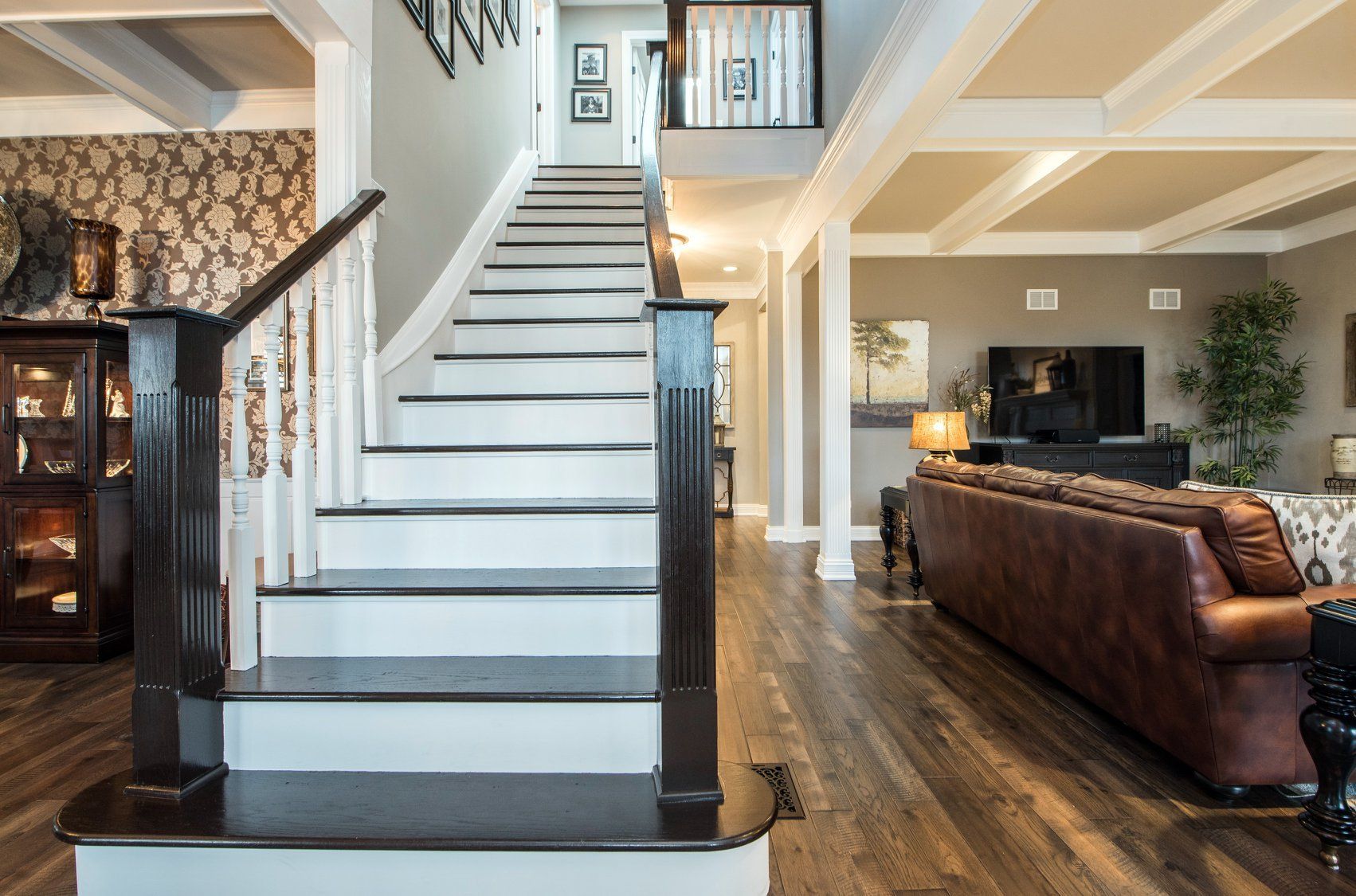 a living room with a couch and stairs leading up to the second floor .