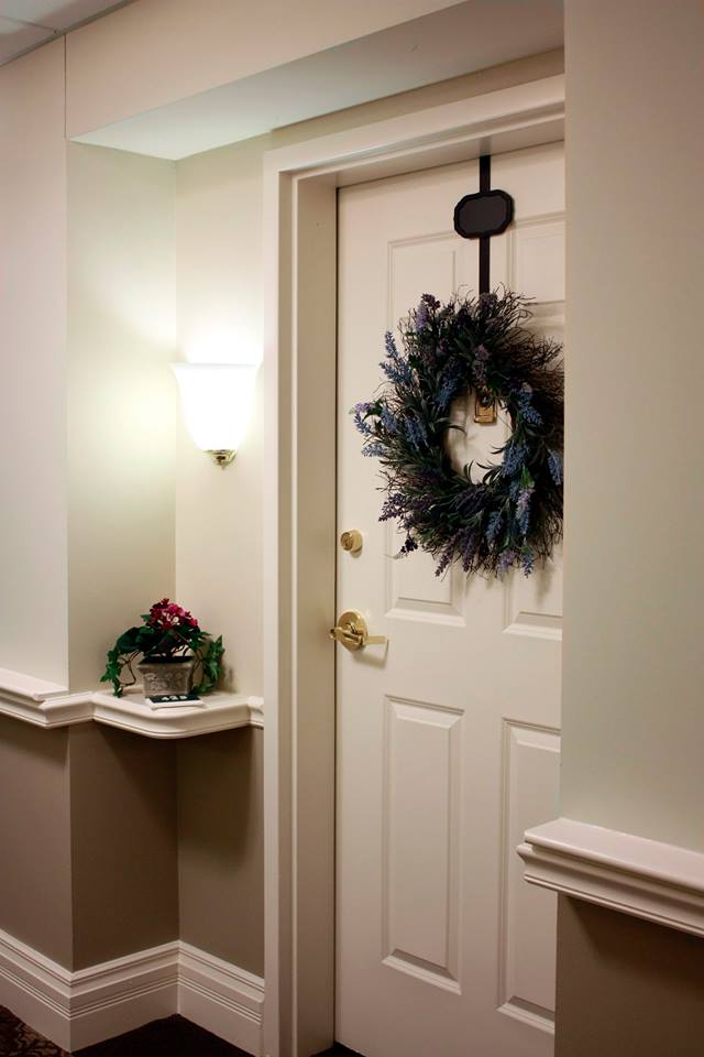 a white door with a wreath hanging on it