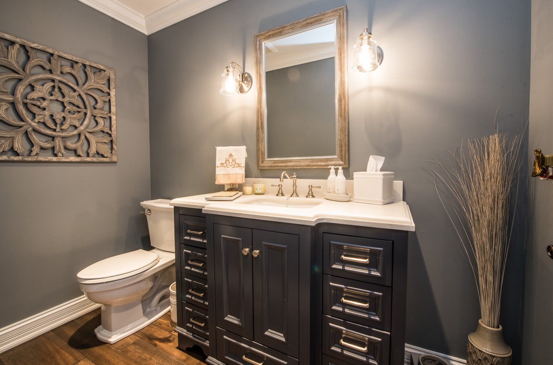 a bathroom with a toilet , sink and mirror .