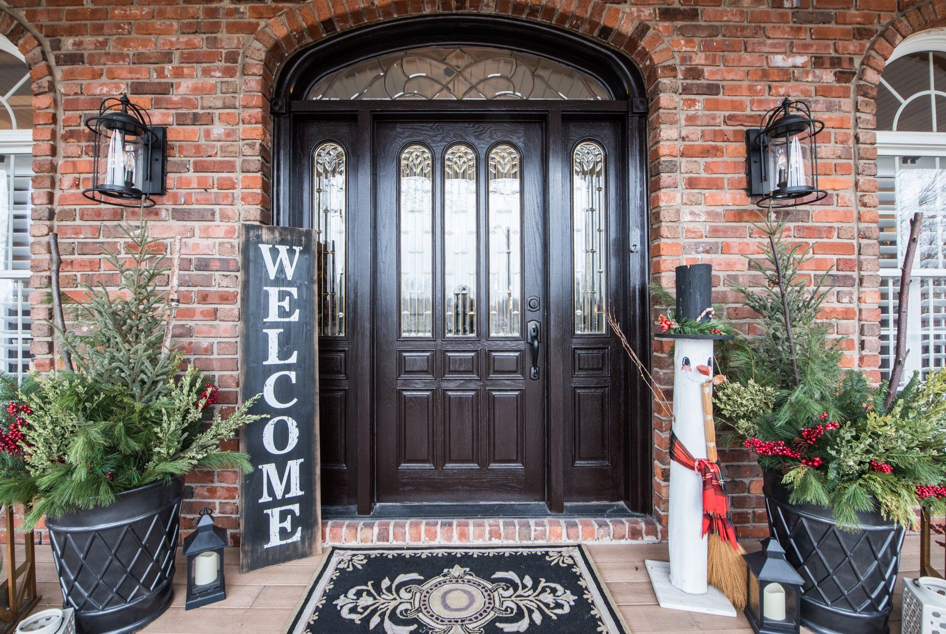 a brick house with a welcome sign in front of the door .