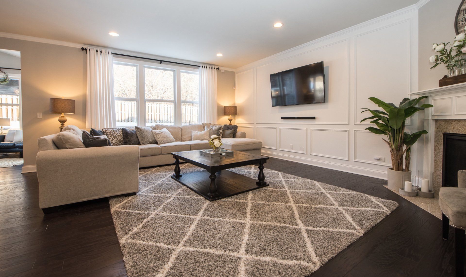 a living room with a couch , chair , coffee table , television and fireplace .