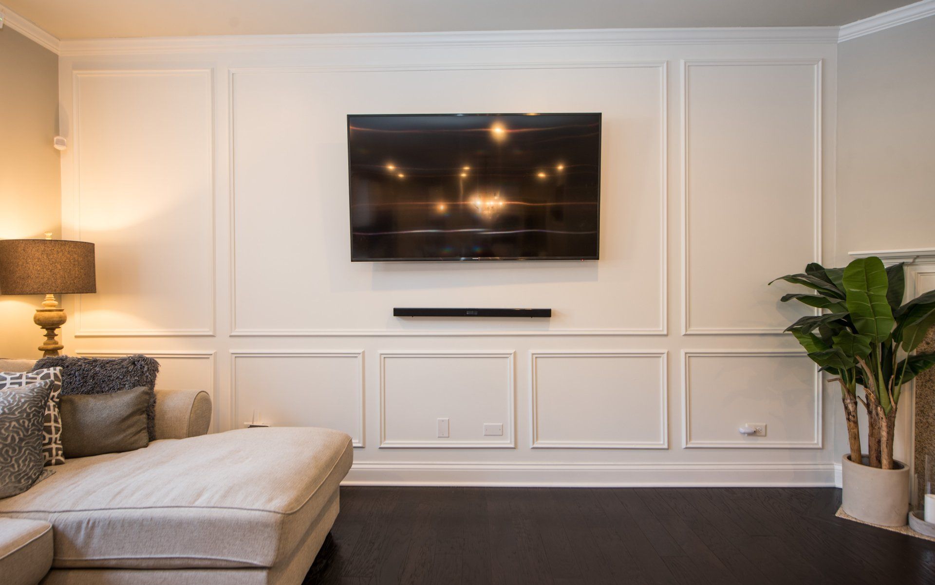 a living room with a couch and a flat screen tv on the wall .