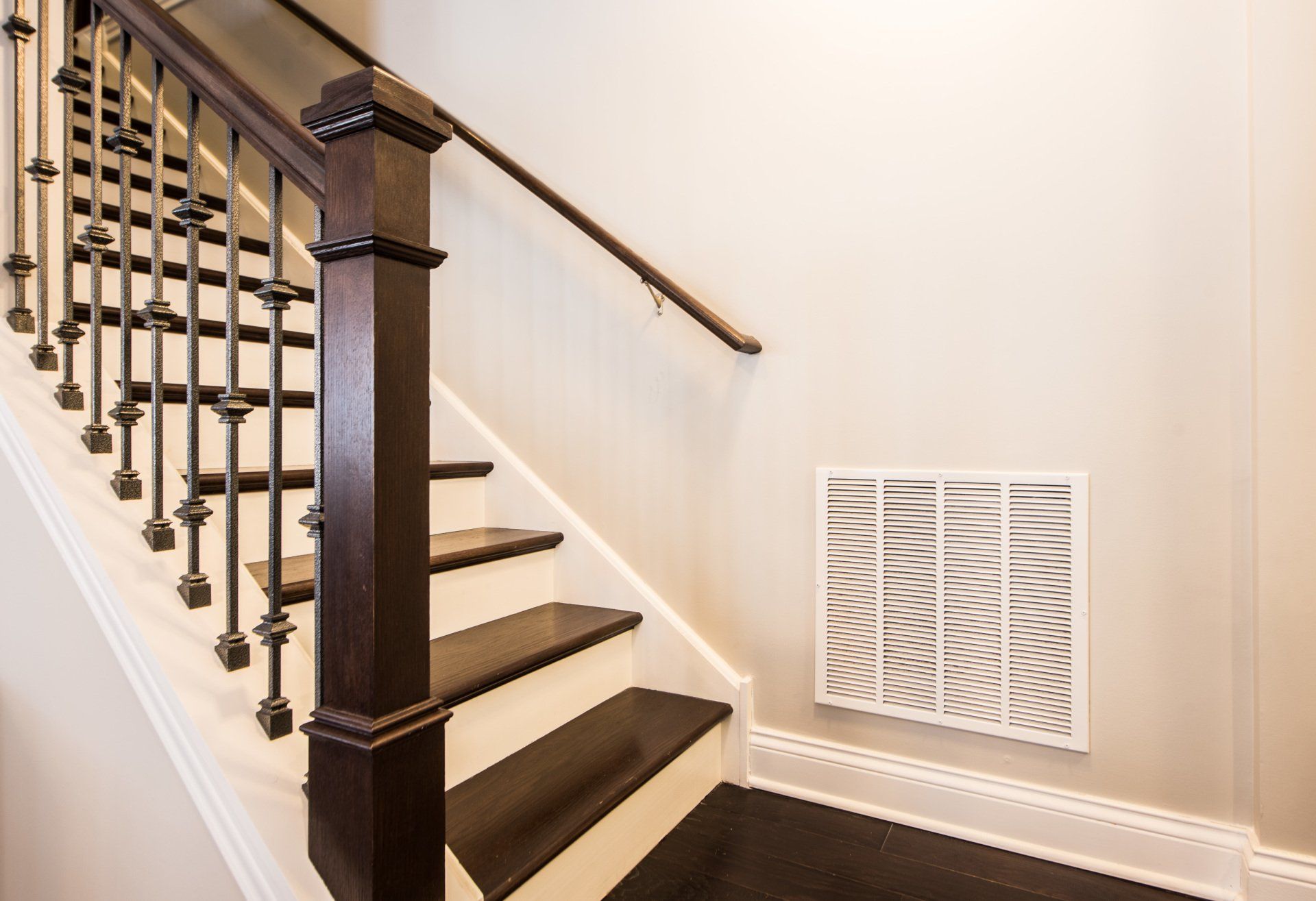 a staircase with a wooden railing and white steps