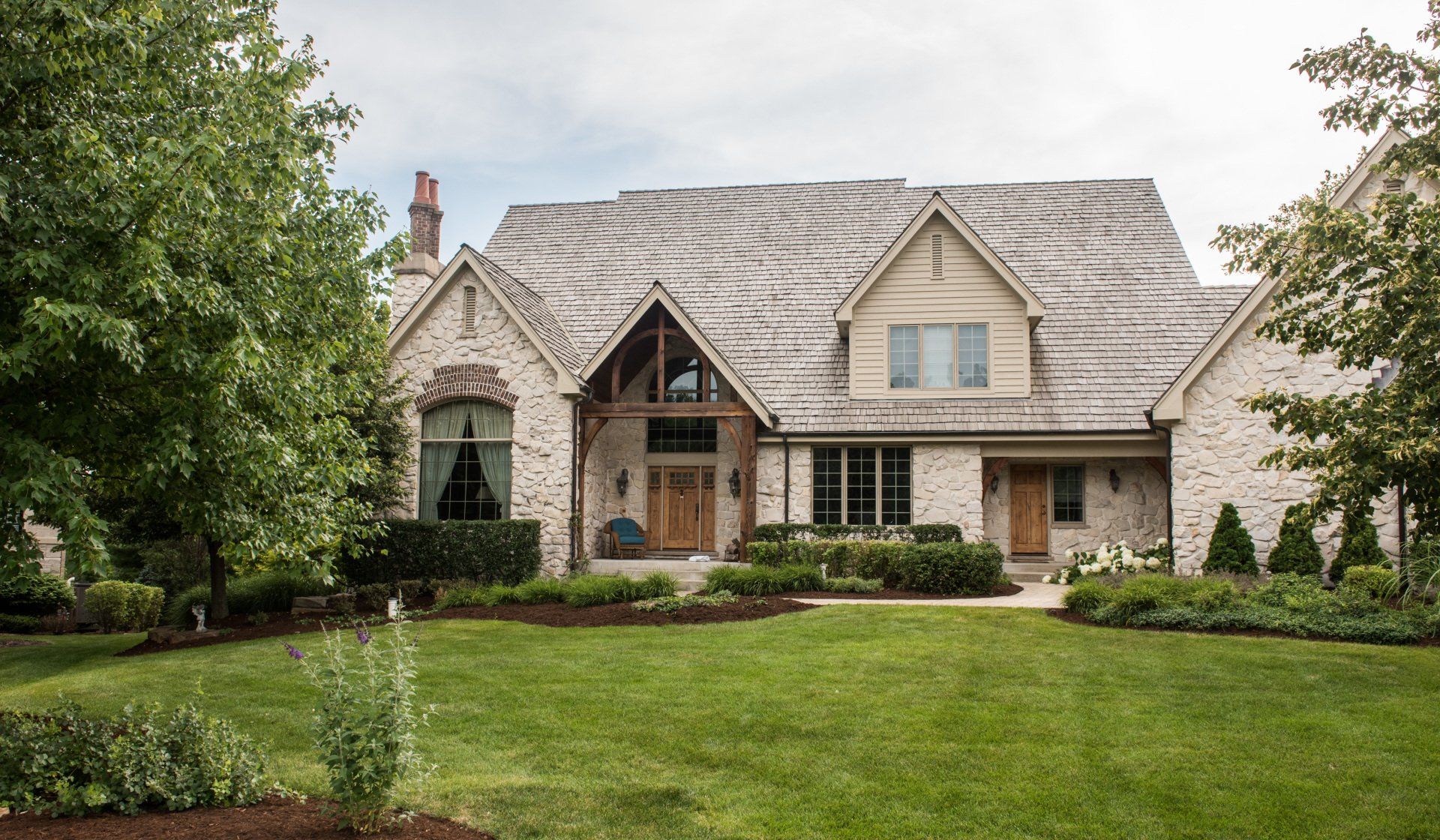 a large brick house with a large lawn in front of it