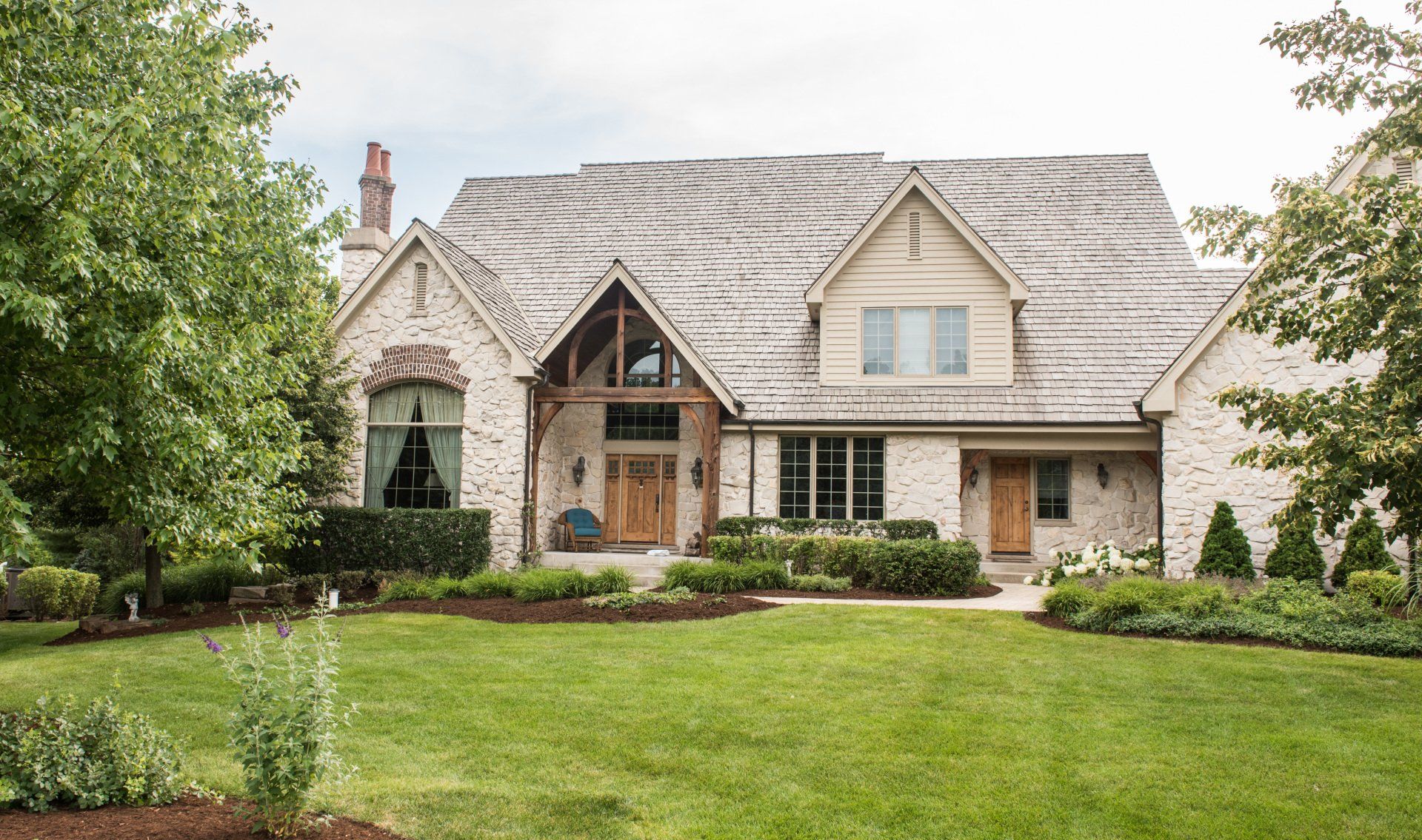 a large brick house with a large lawn in front of it