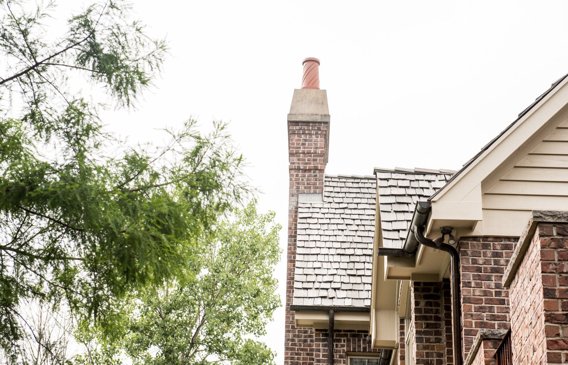 a brick house with a chimney on the roof .