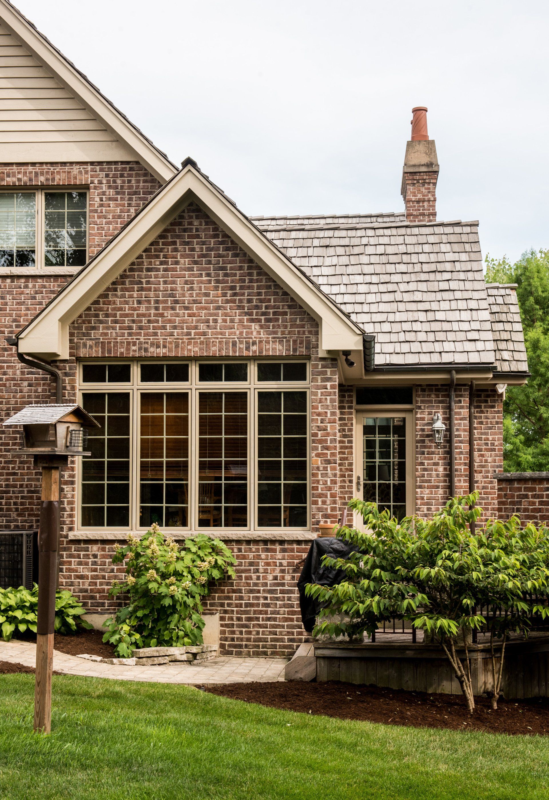 a brick house with a chimney and a lot of windows