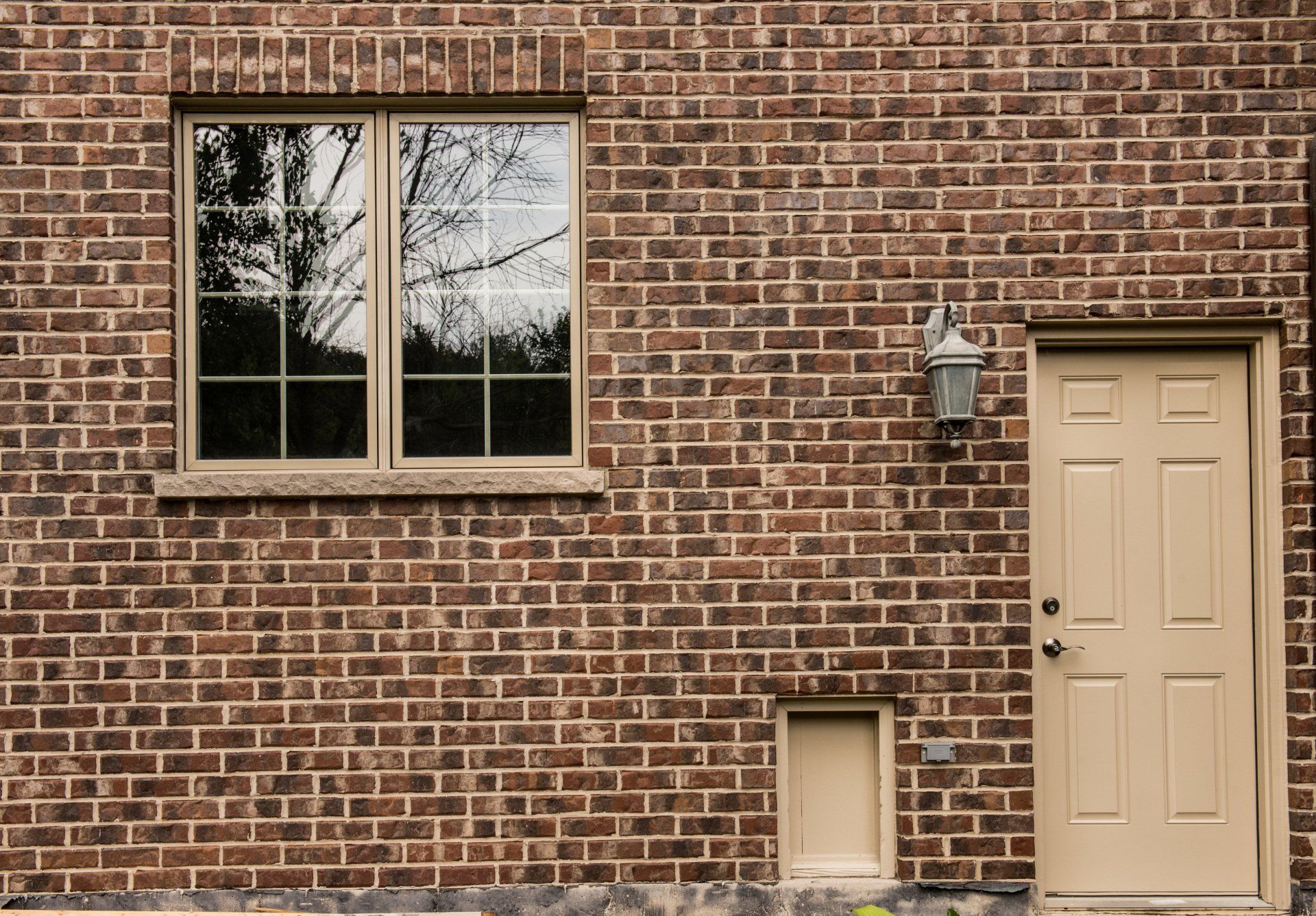 a brick wall with a window and a door