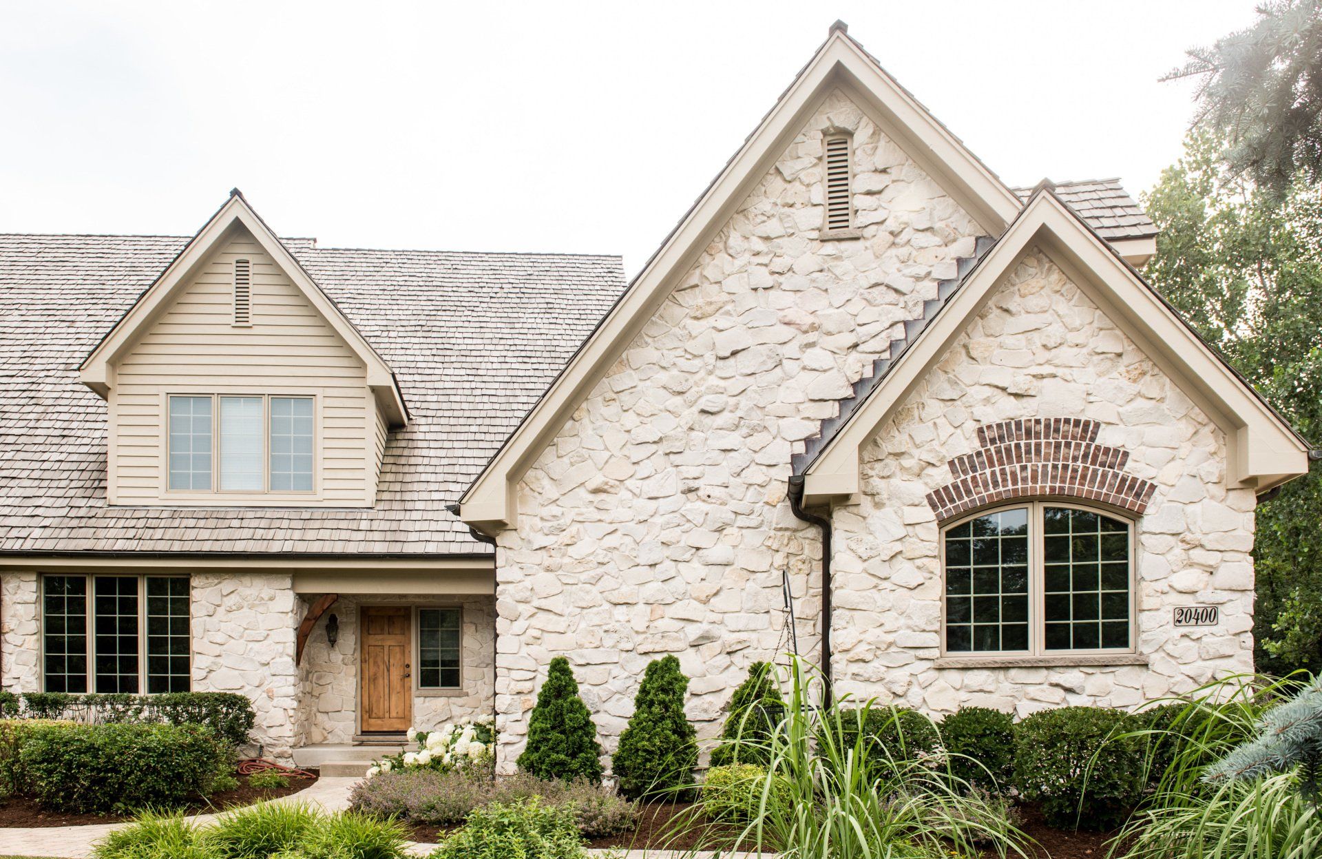 a large white brick house with a lot of windows