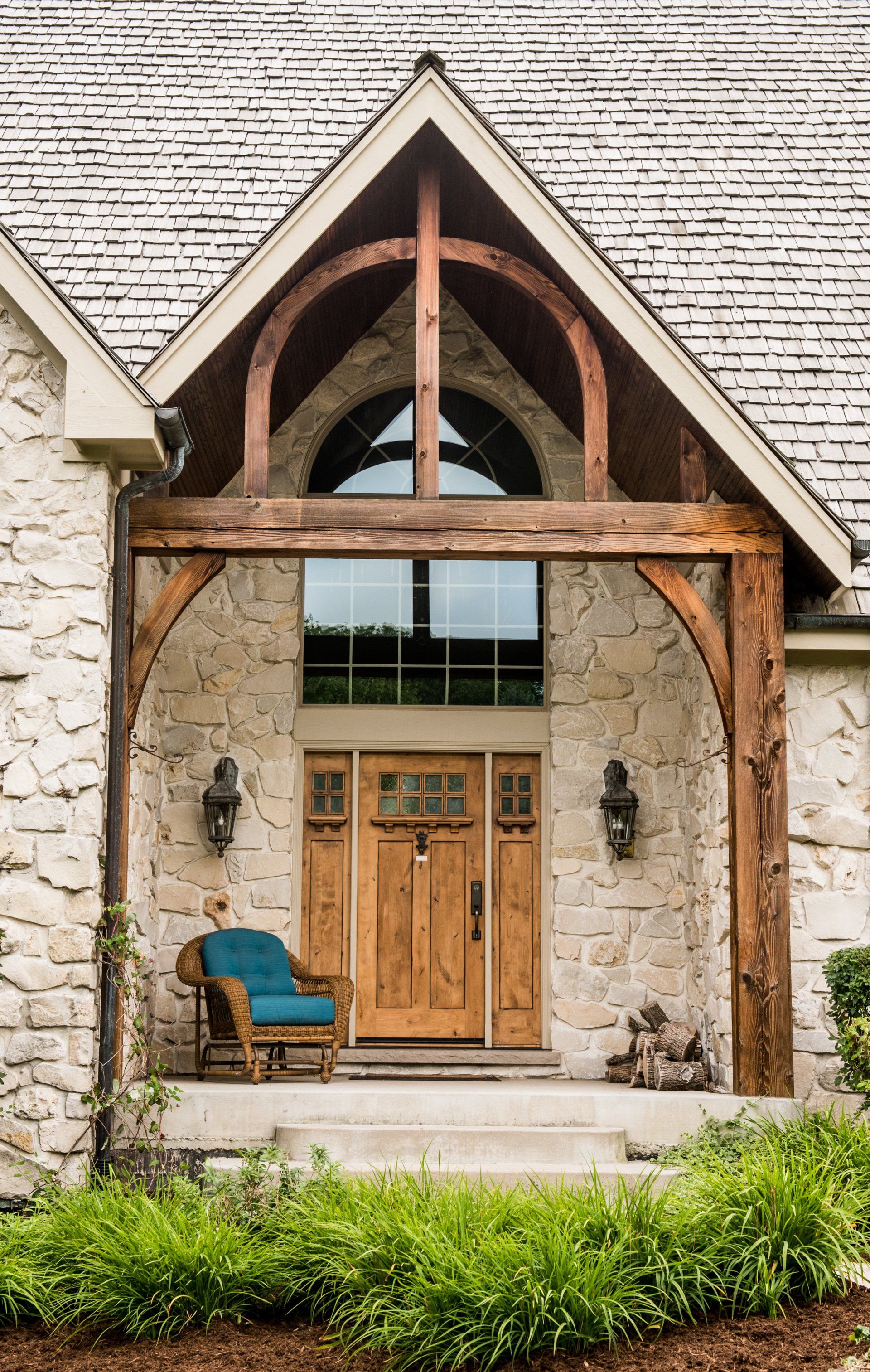 a stone house with a wooden porch and a wooden door .