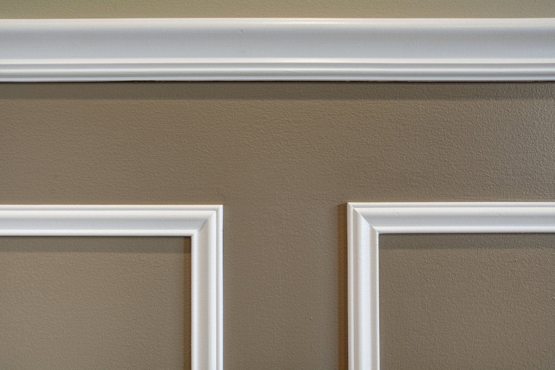 a close up of a wall with white molding on it .