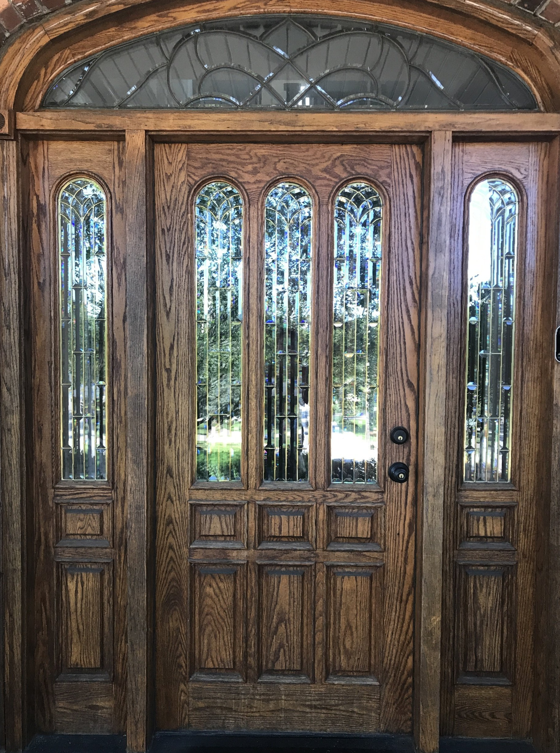 a large wooden door with stained glass windows