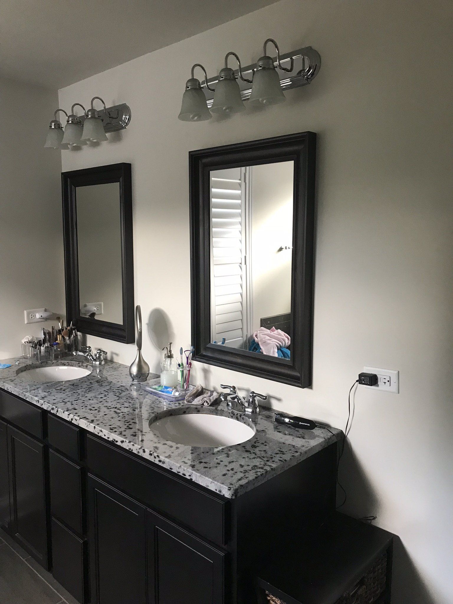 a bathroom with two sinks and two mirrors .