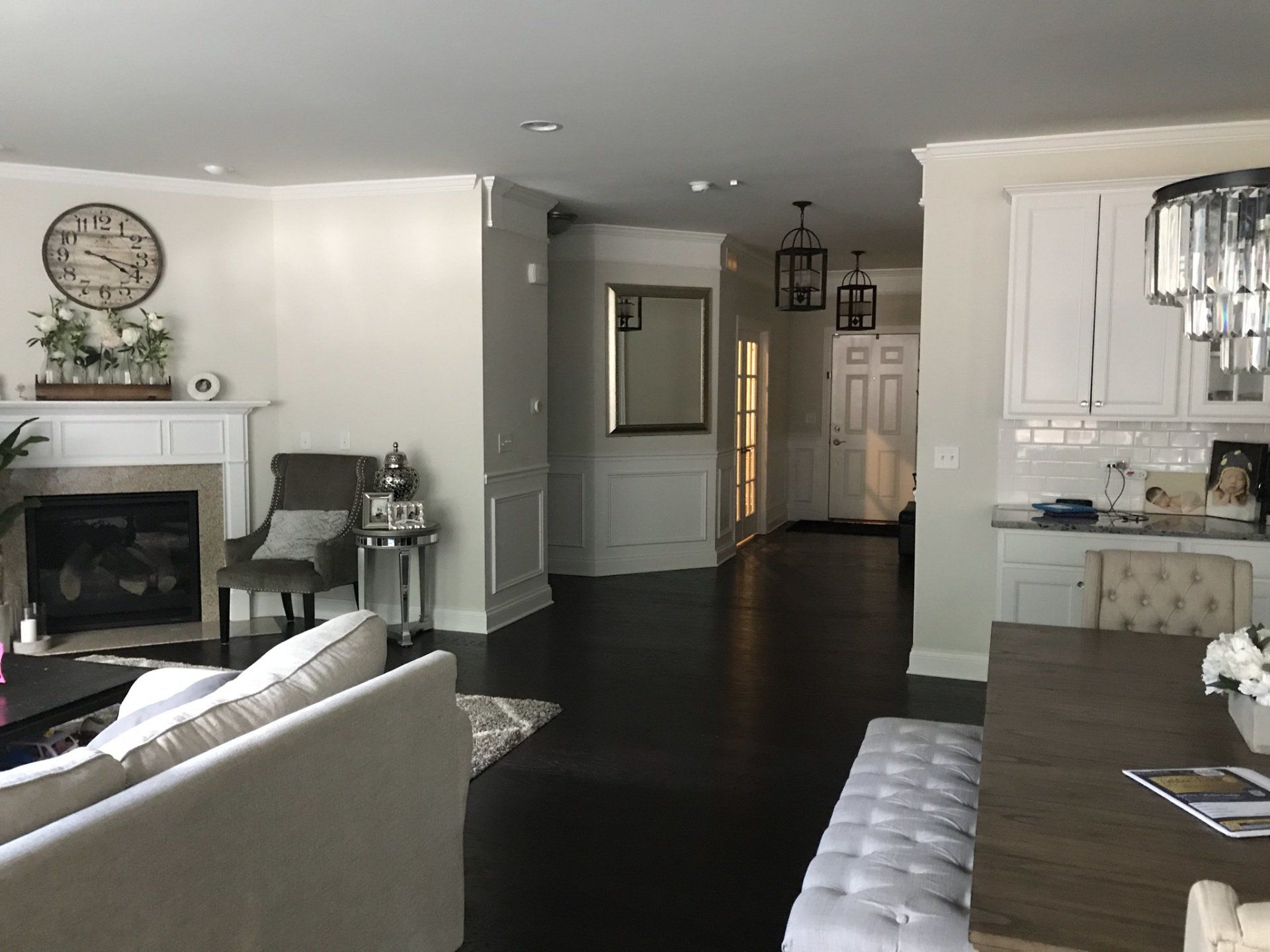a living room with a fireplace and a clock on the wall