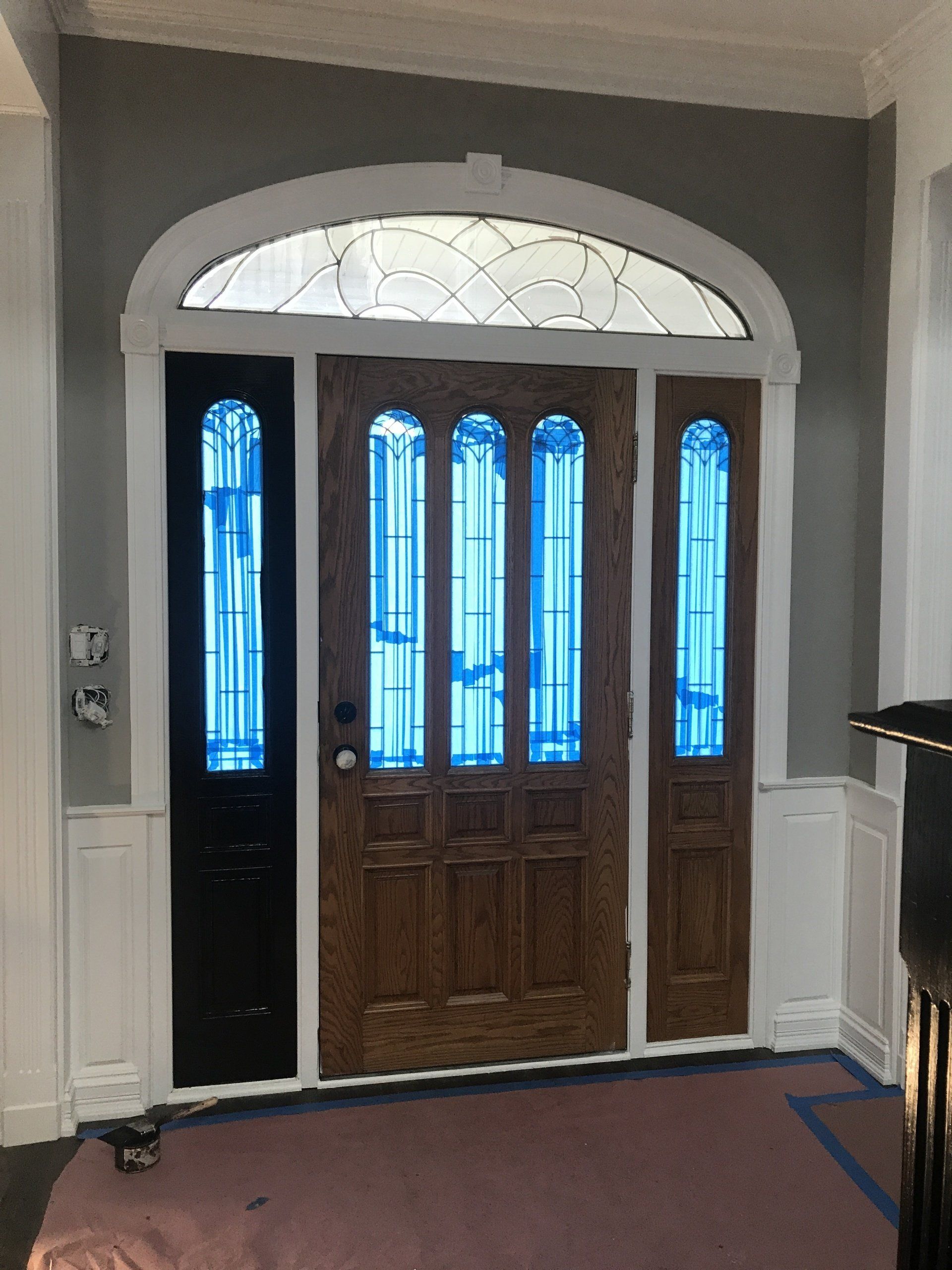 a wooden door with stained glass windows in a room