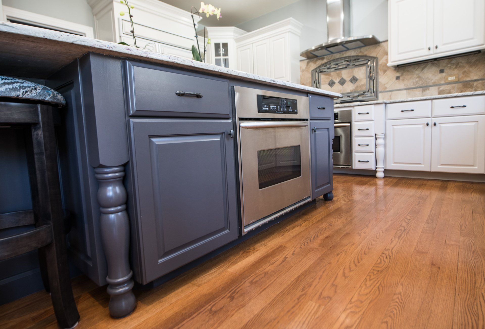 a kitchen with a large island and stainless steel appliances .