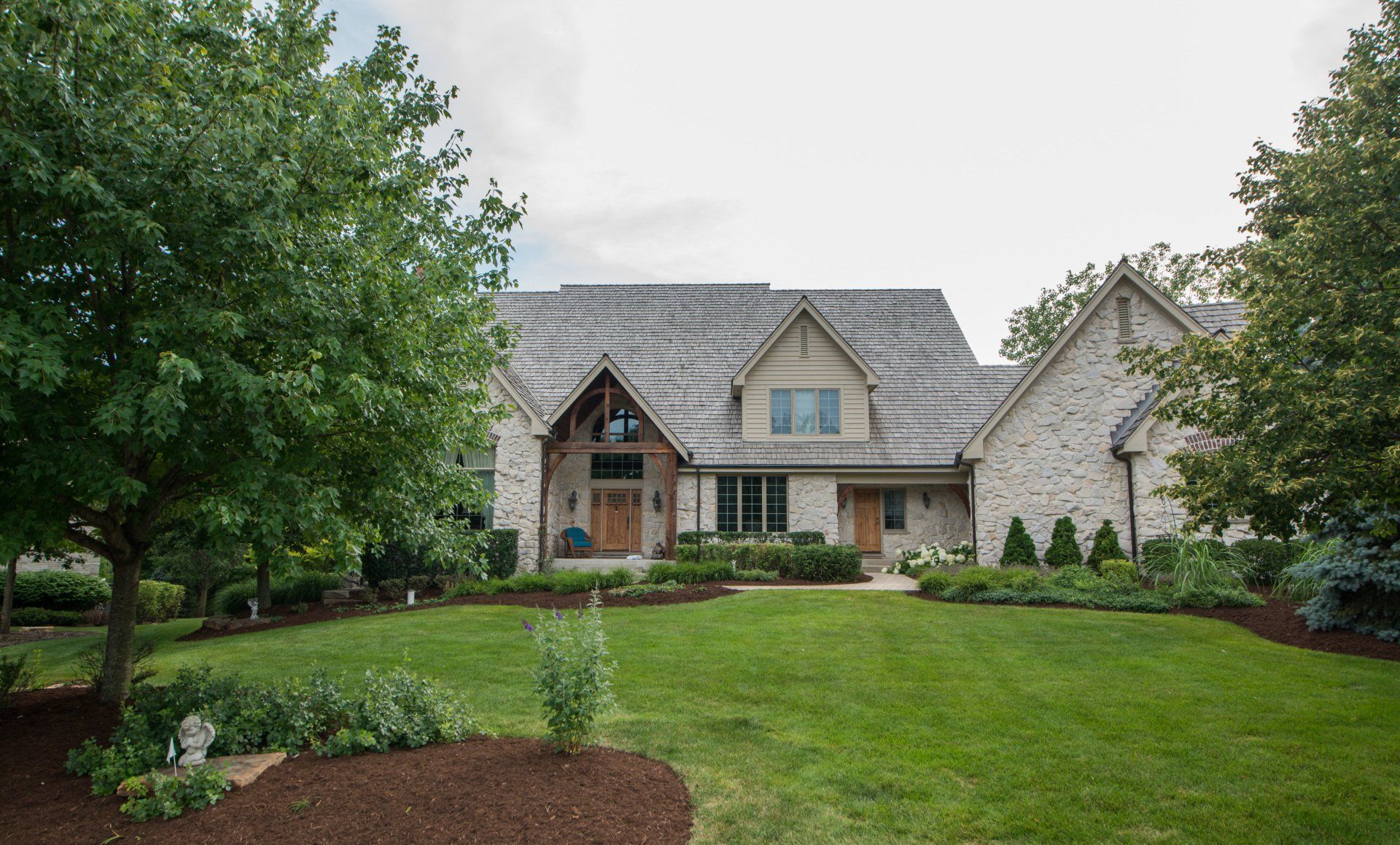 a large house with a lush green lawn in front of it