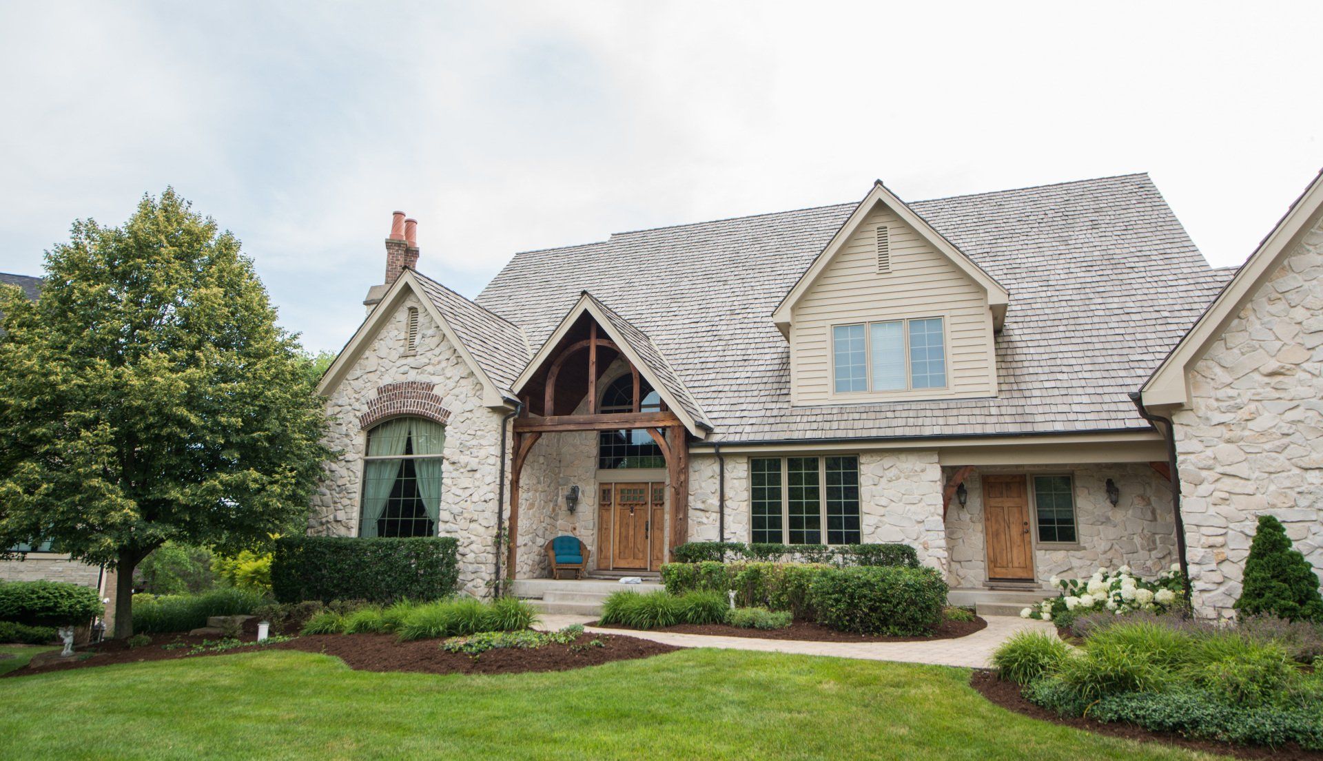 a large brick house with a large lawn in front of it