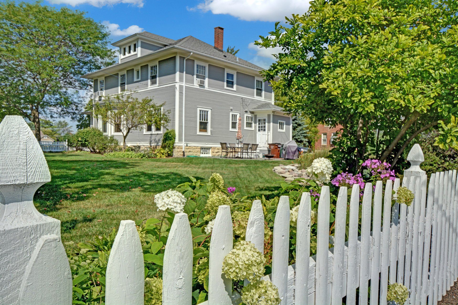 a large house with a white picket fence in front of it