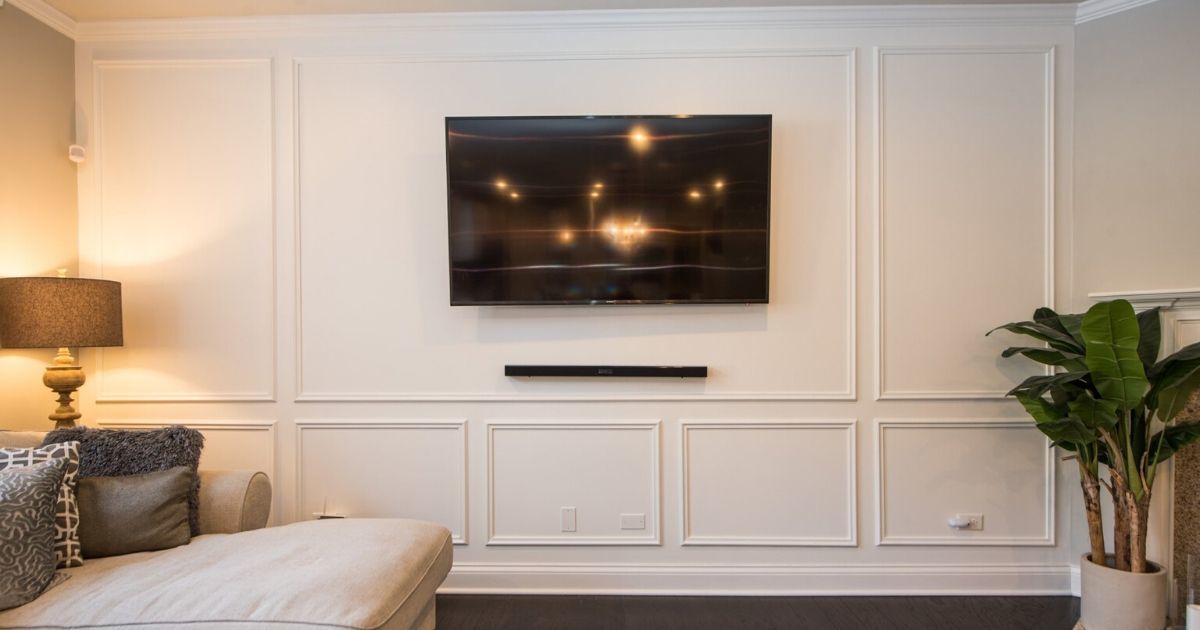 a living room with a flat screen tv mounted on the wall .