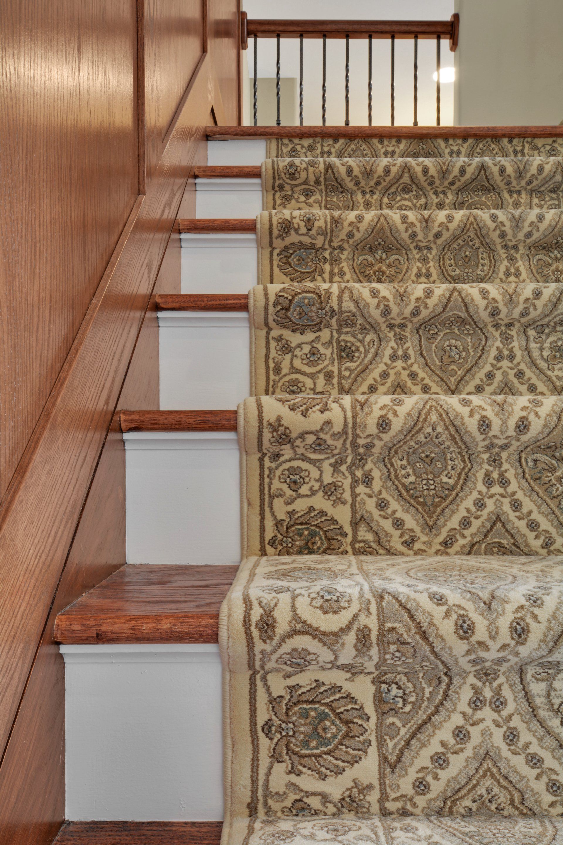 a close up of a staircase with a carpet on the steps .