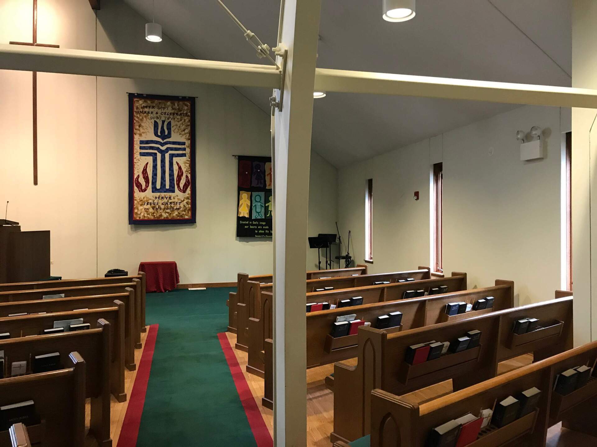 an empty church with a cross on the wall