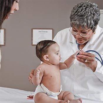 Doctor Checking Up a baby — Doctor in Smyrna, TN