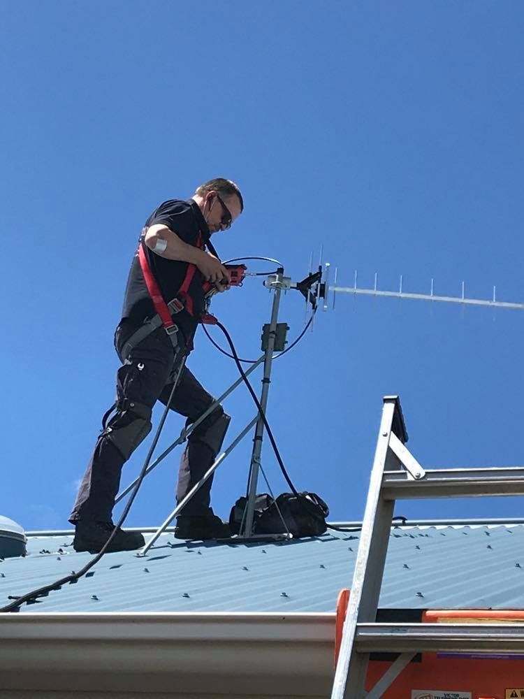 Anthony installing new TV antenna on roof