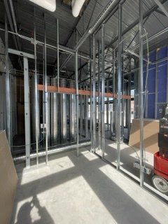 A room under construction with a lot of metal frames and pipes.