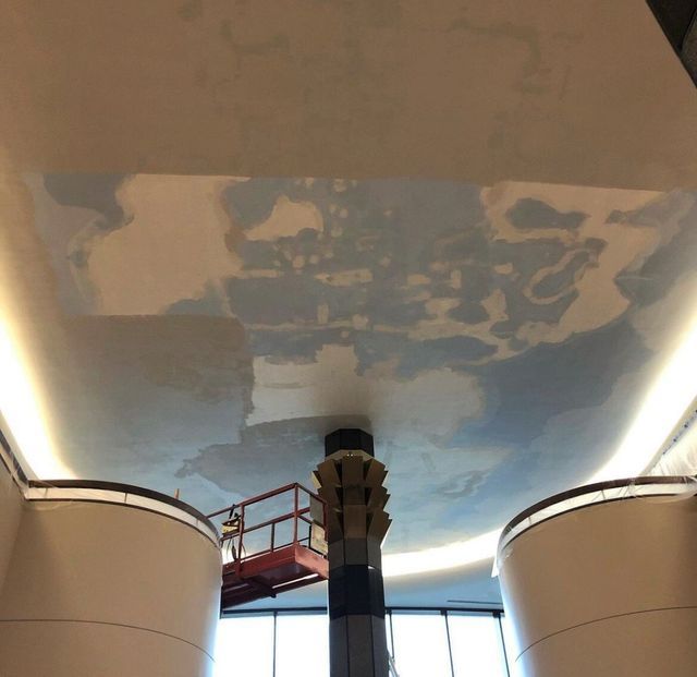A ceiling is being painted in a building