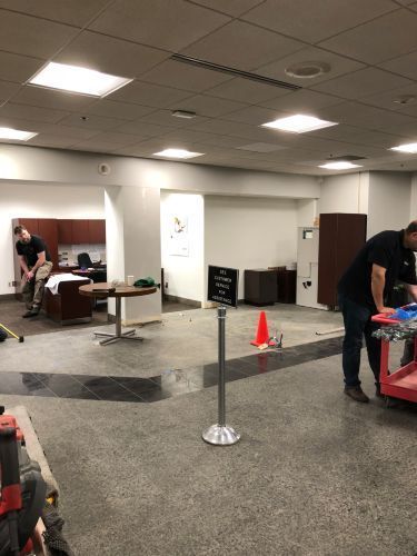 A man is standing in an empty room in a building.