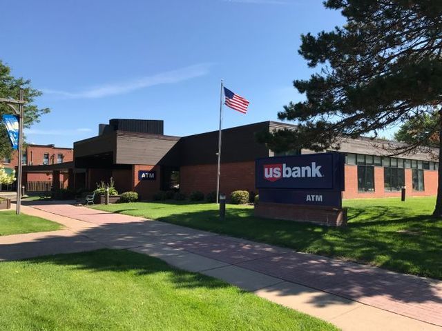 A us bank building with a sign in front of it