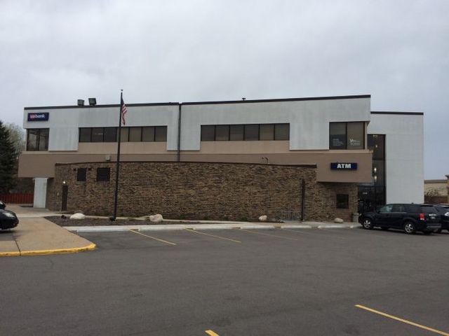 A large building with a parking lot in front of it