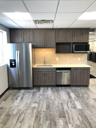 A kitchen with stainless steel appliances and wooden cabinets.