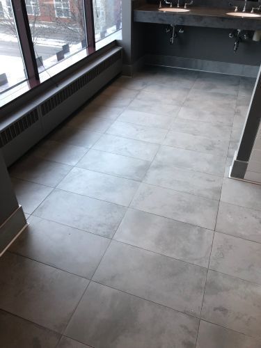 A bathroom with two sinks and a tiled floor.