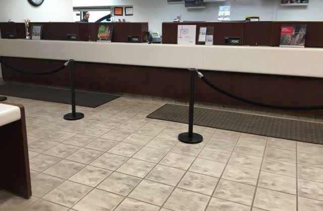 A bank counter with a black rope between it