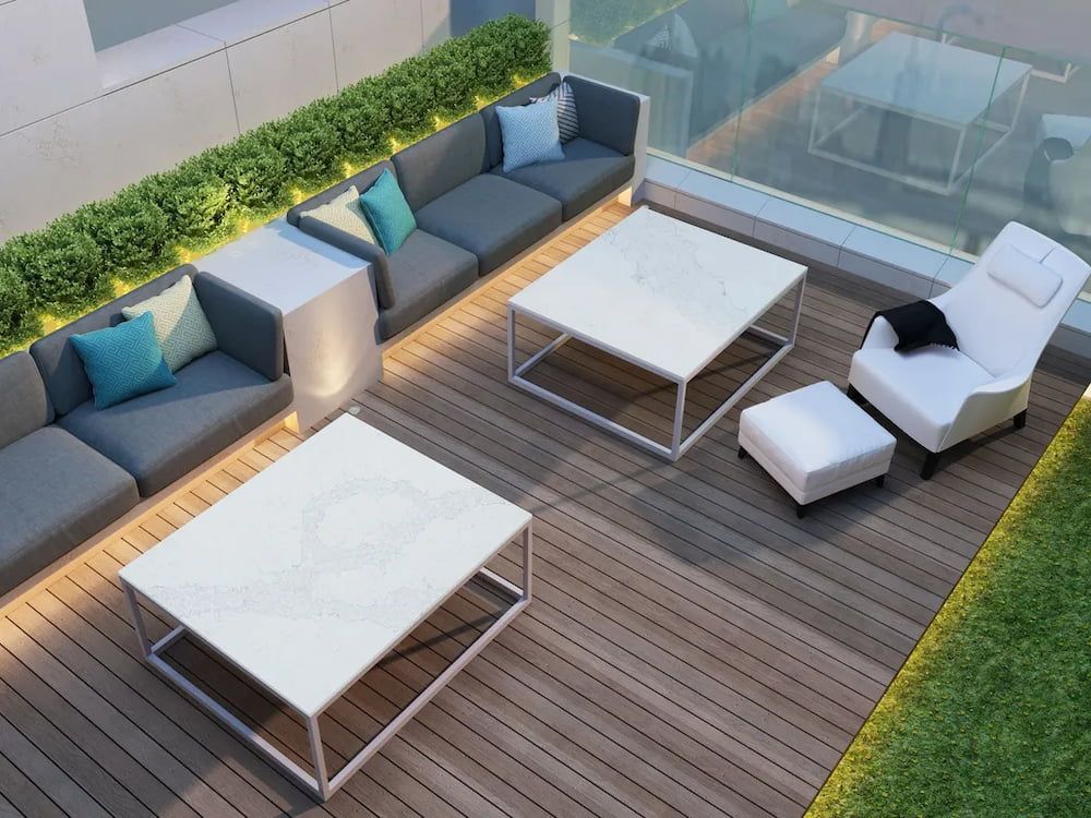 An aerial view of a patio with a couch , table , chair and ottoman — Better Stone in Caloundra West, QLD