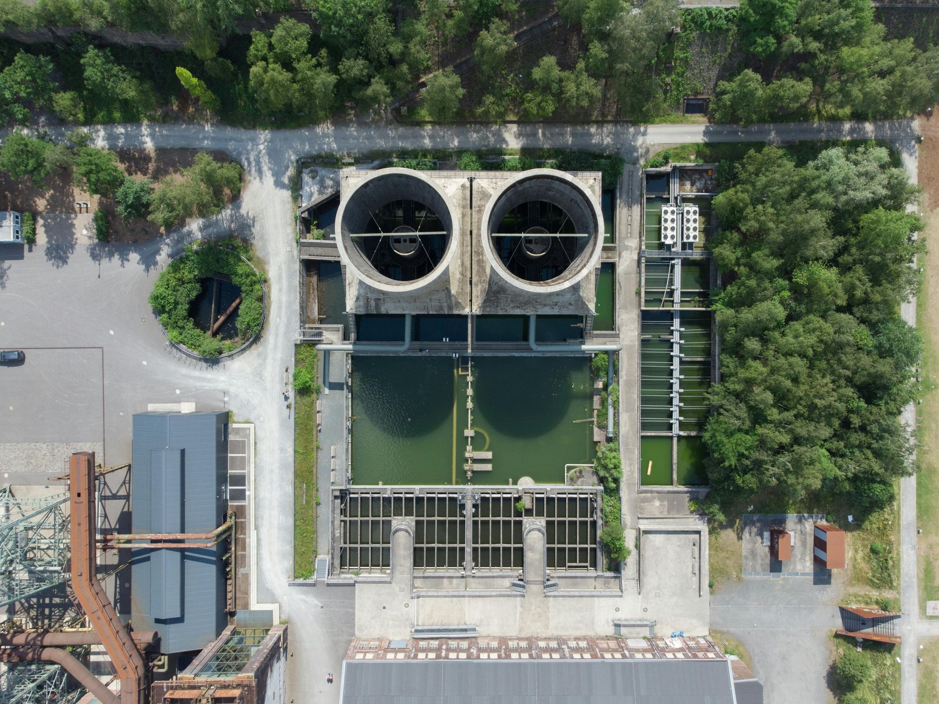 Overhead view of an industrial water treatment facility with two large cooling towers