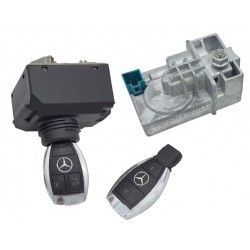 Mercedes-Benz car key and black key fob next to a silver ignition switch module