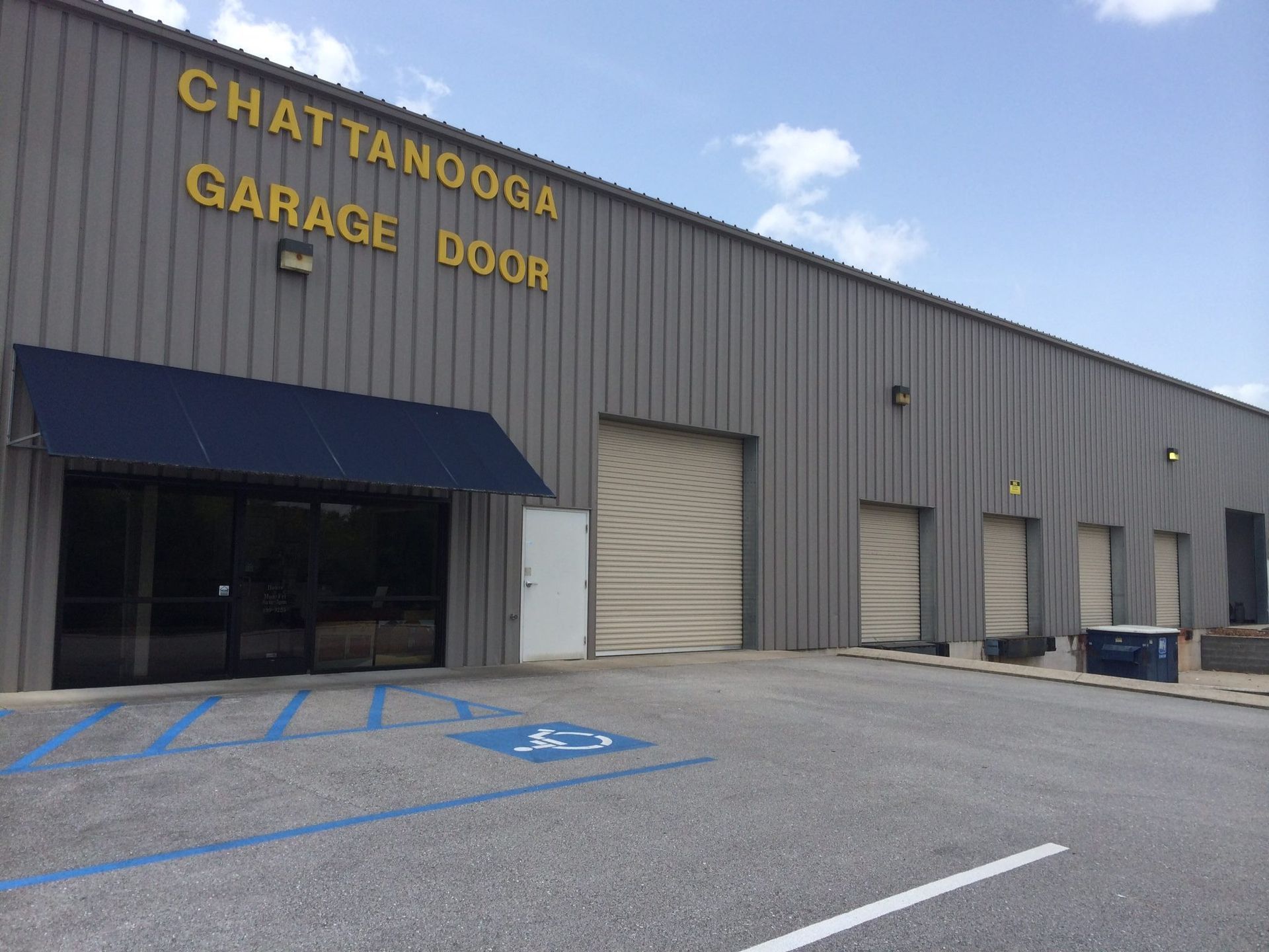 Chattanooga Garage Door building with storefront entrance and multiple garage doors; blue and gray exterior.