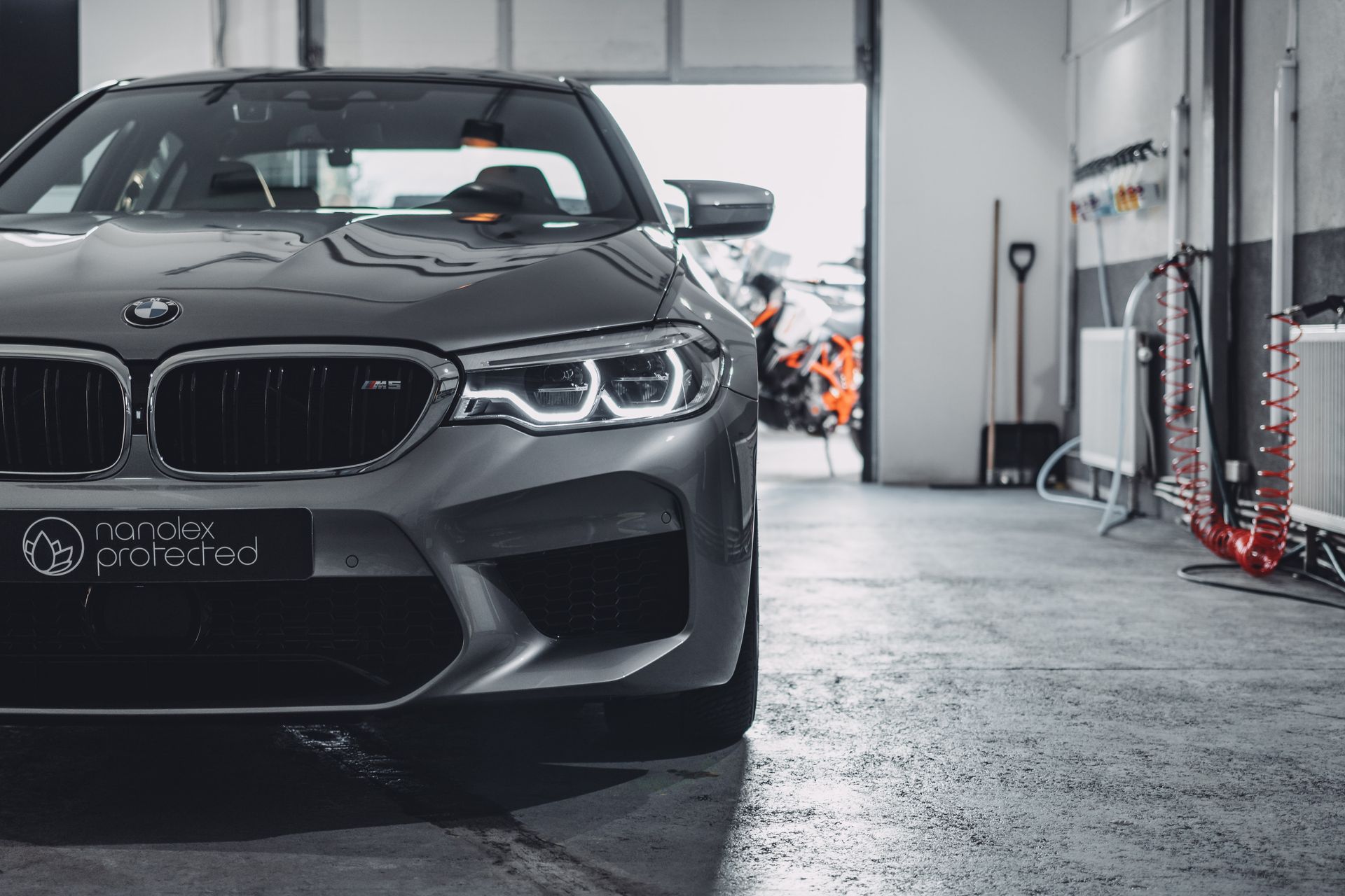 A bmw m5 is parked in a garage.