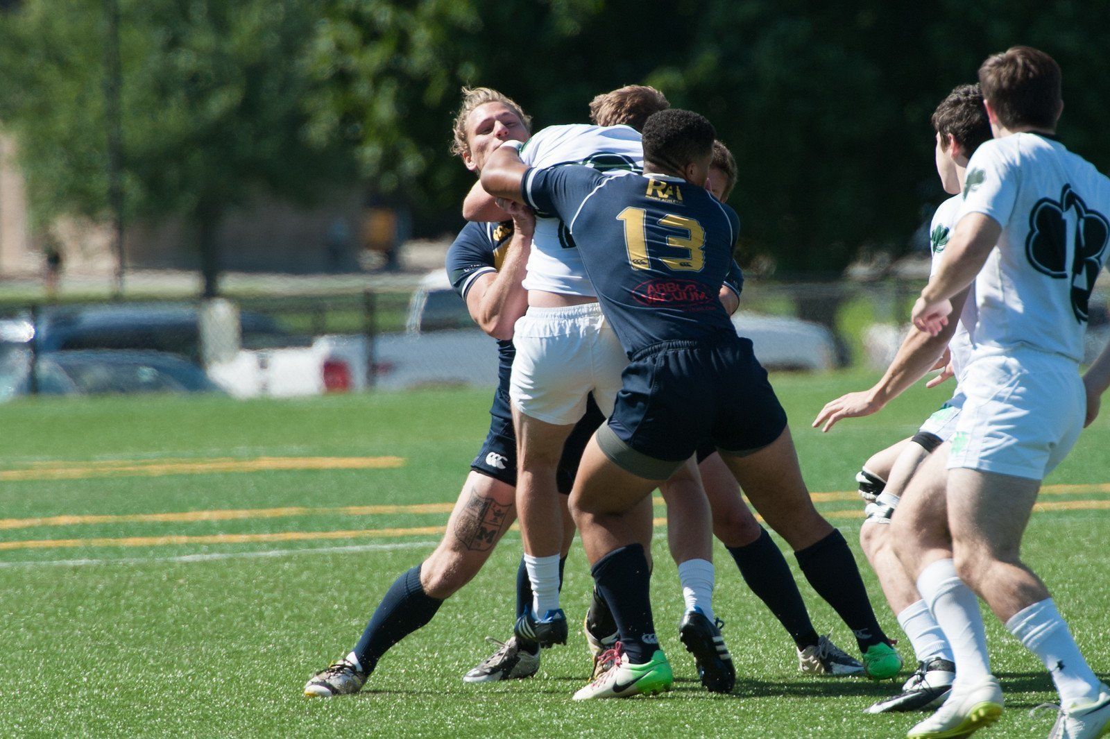 A group of young men are playing rugby on a field.