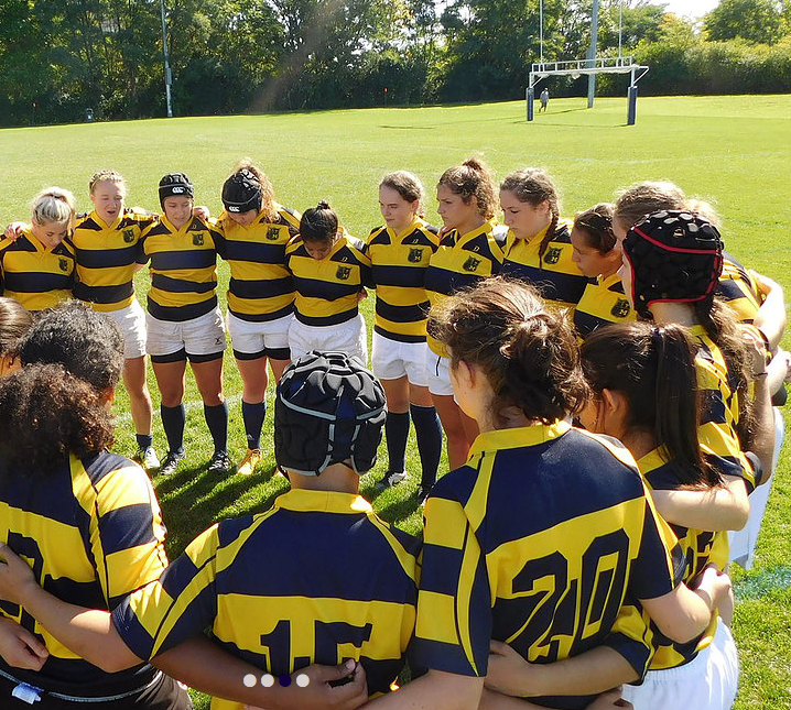 A group of people wearing yellow and blue striped shirts with the number 20 on the back