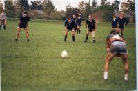A group of people are playing soccer on a field.