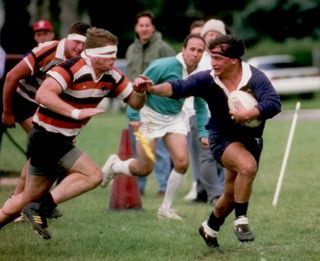 A group of men are playing rugby on a field